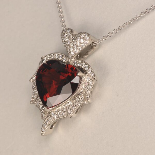 Stunning heart shaped rhodolite and diamond pendant. Brand new