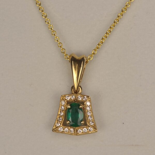 Fine emerald and diamond pendant set in 14K yellow gold