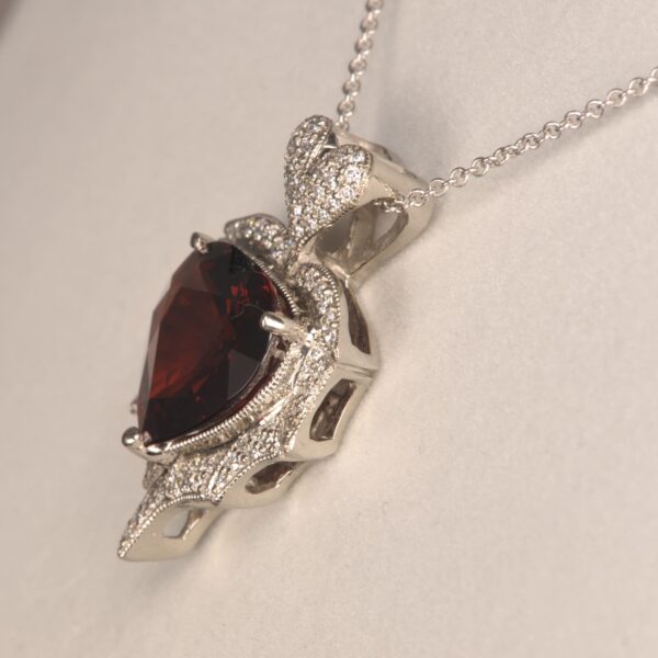 Stunning heart shaped rhodolite and diamond pendant. Brand new