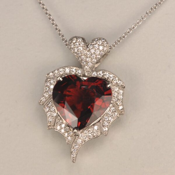 Stunning heart shaped rhodolite and diamond pendant. Brand new