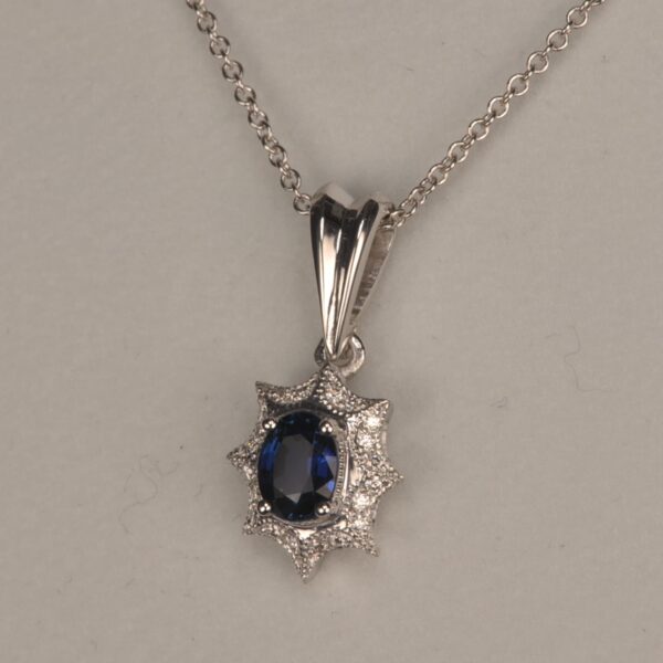 Blue sapphire and diamond pendant with chain, midnight blue color