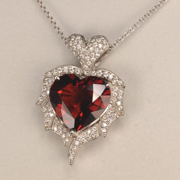 Stunning heart shaped rhodolite and diamond pendant. Brand new