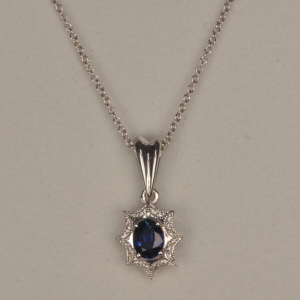 Blue sapphire and diamond pendant with chain, midnight blue color