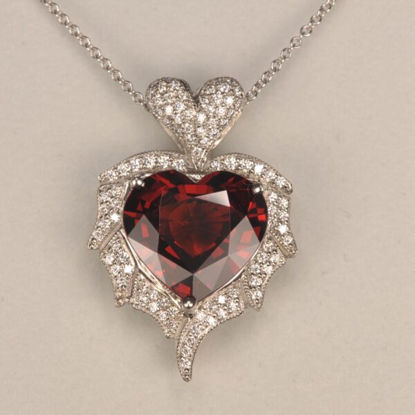 Stunning heart shaped rhodolite and diamond pendant. Brand new