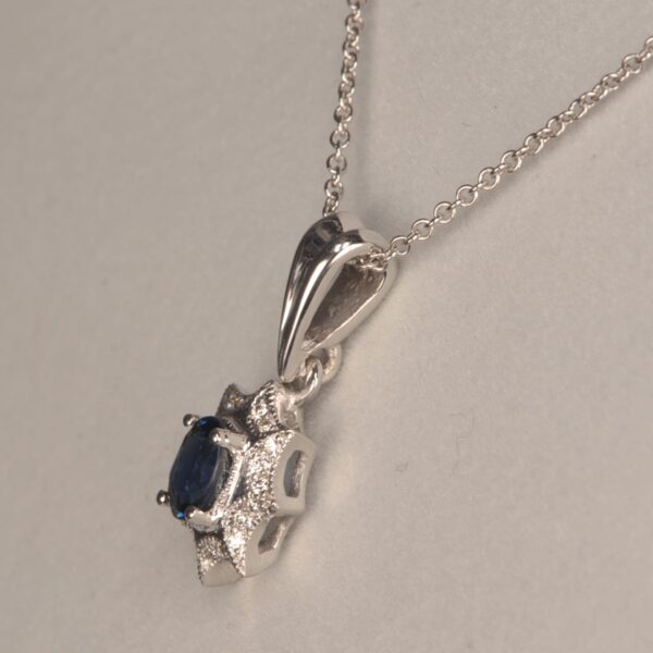 Blue sapphire and diamond pendant with chain, midnight blue color