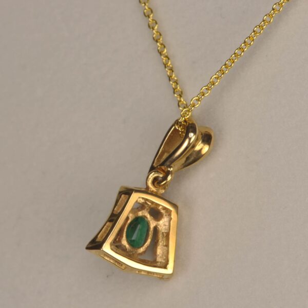 Fine emerald and diamond pendant set in 14K yellow gold