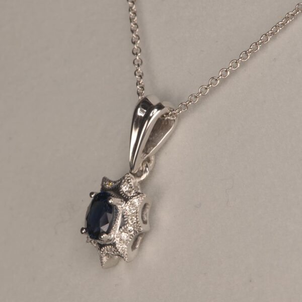 Blue sapphire and diamond pendant with chain, midnight blue color