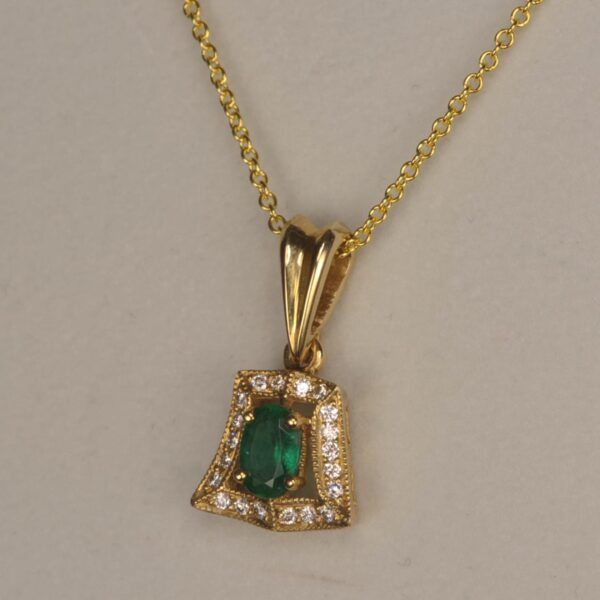 Fine emerald and diamond pendant set in 14K yellow gold